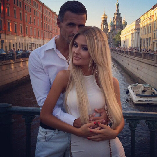 An adult couple sharing a close and affectionate moment while travelling